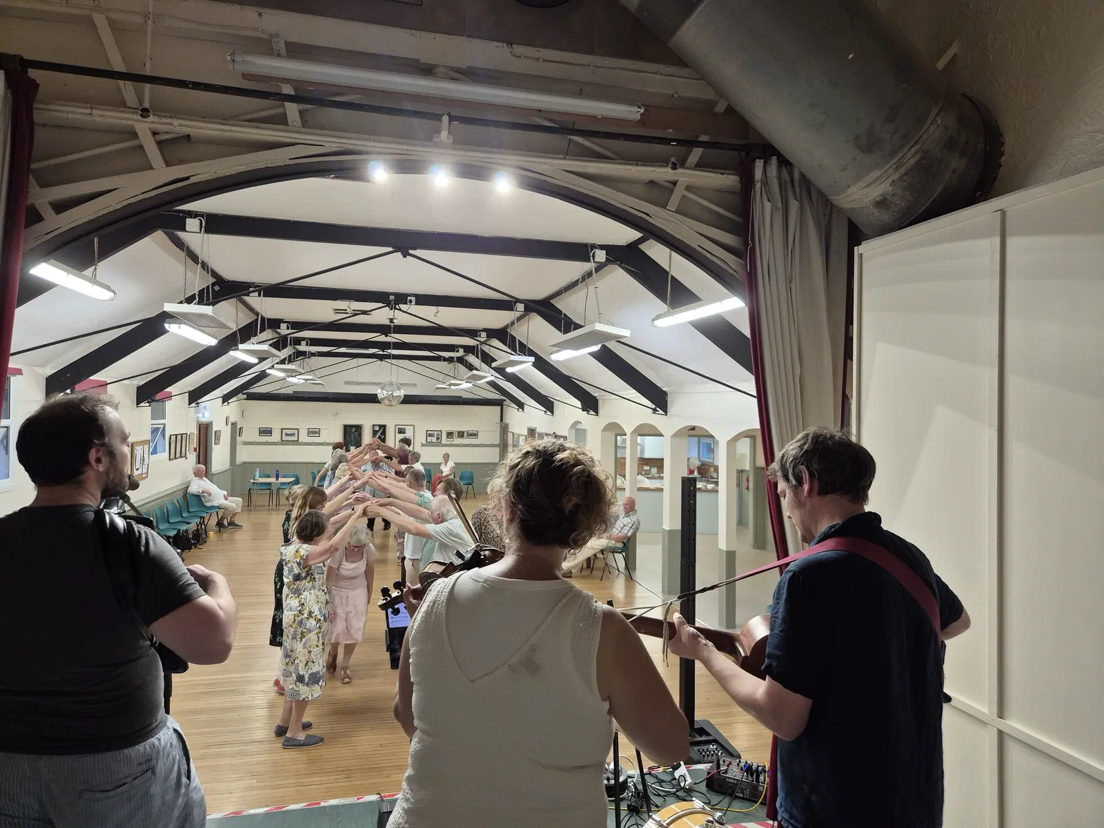 Dancers forming an arch as the band plays