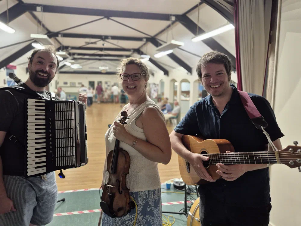 Tom, Sarah and Dom together at a village hall gig